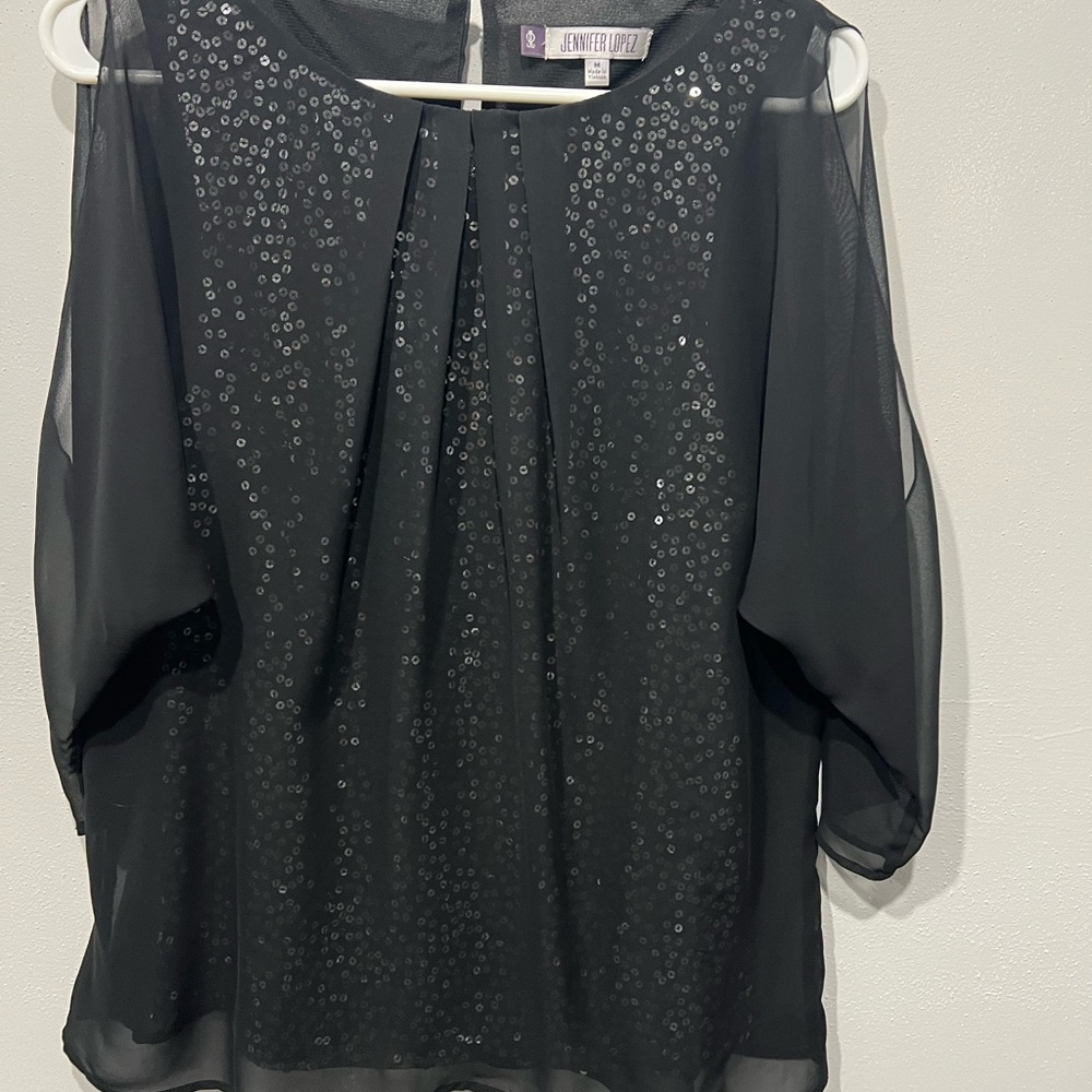 Jennifer Lopez Black sequin blouse with sheer sleeves and a flowy design. MEDIUM